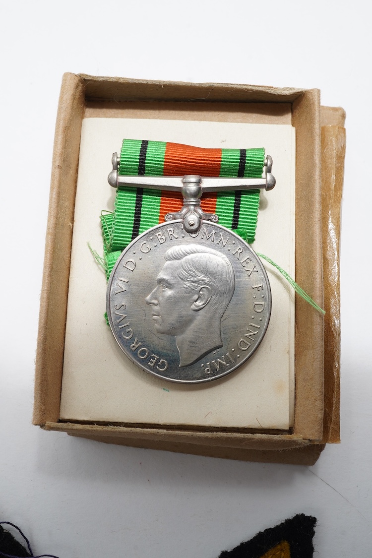 A First World War Mons Star trio awarded to Capt. A.D. Lowdell, with a clasp for 5th Aug-22nd Nov 1914, and oakleaf - mention in dispatches, together with the miniature set, plus a WWII Defence medal in its original card